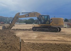 Photo of excavator breaking ground for The Reserve